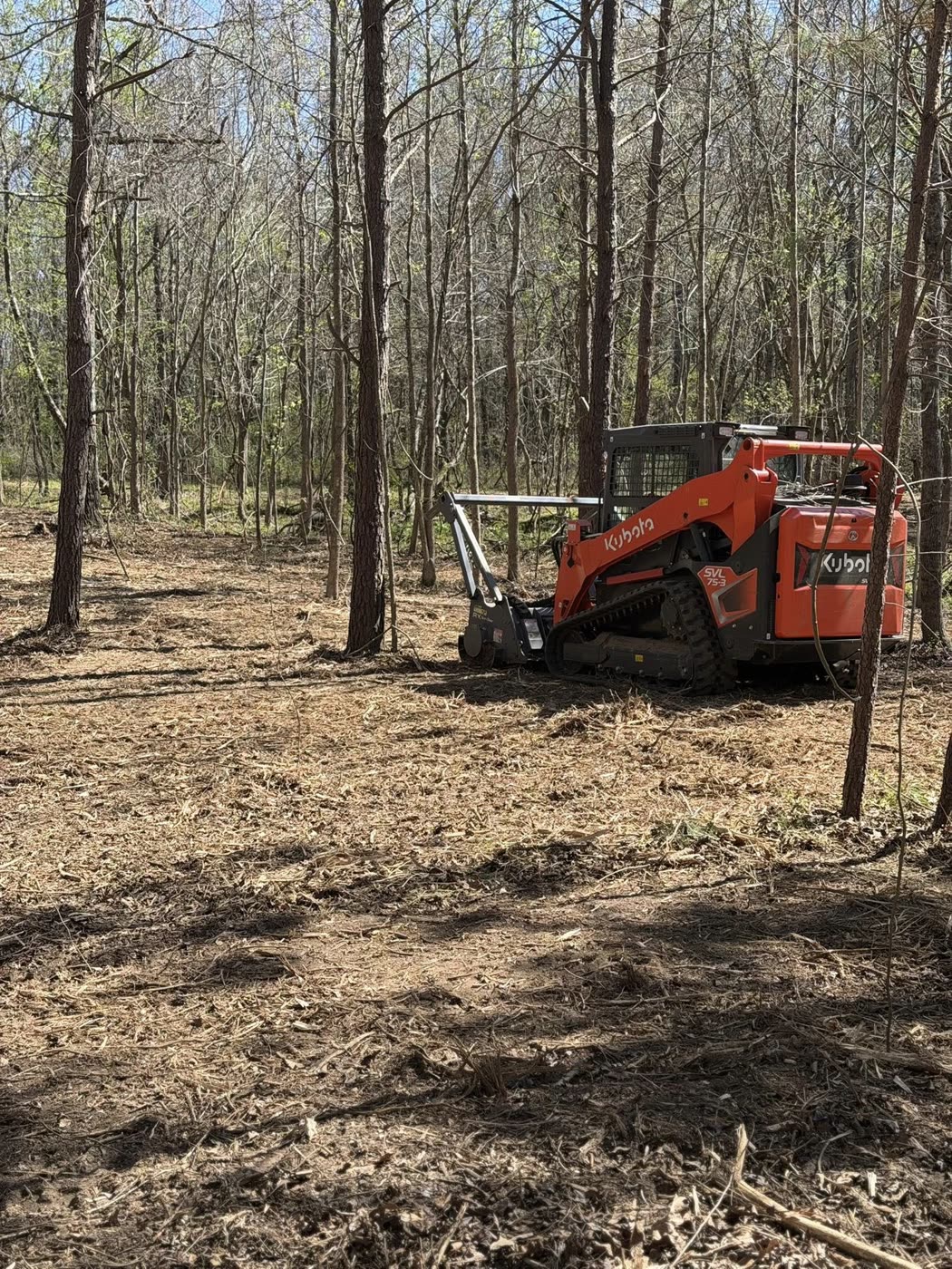 Kubota track loader with mulcher attachment on freshly cleared ground